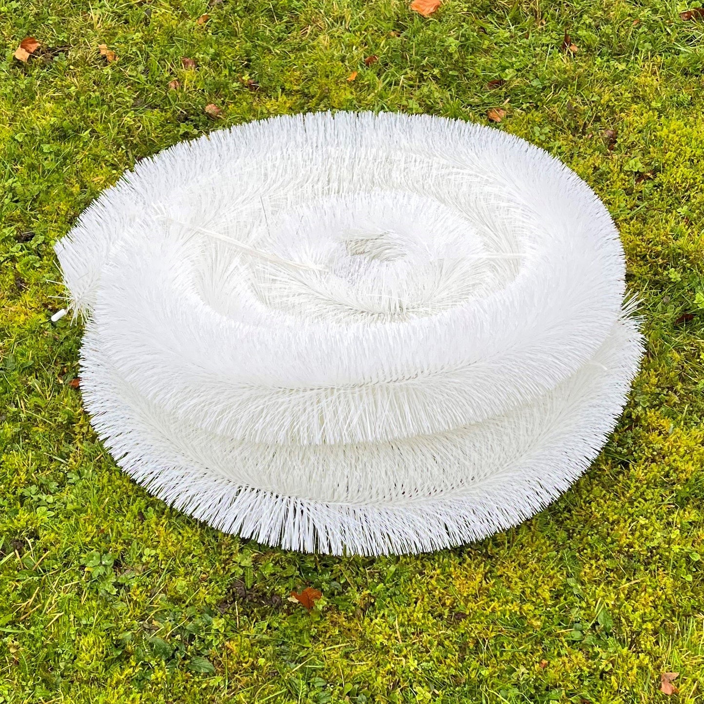 Roll of white gutter guard mesh on grass