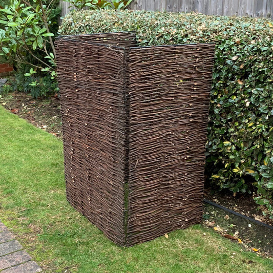 A willow wheelie bin screen made from natural woven willow with a strong metal framework, designed to cover and conceal a wheelie bin.