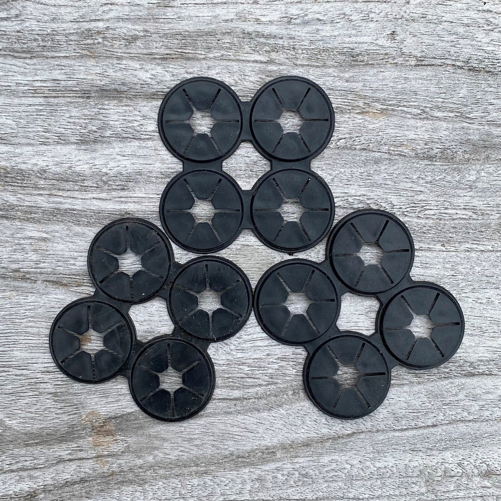 A collection of black bamboo clips arranged on a wooden surface.