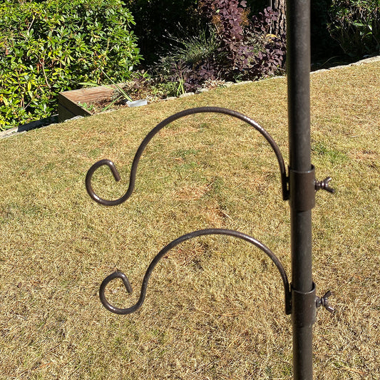 A hammertone finished metal bracket hook designed for bird feeding stations, displayed upright on grass with a blurred background.