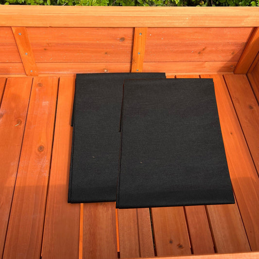 Two black fabric liners placed inside a wooden raised herb planter.