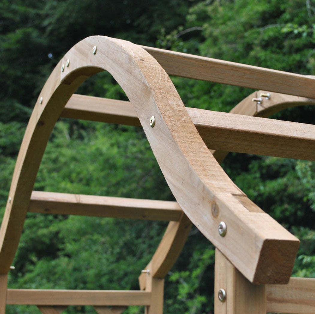 Wooden playground slide with a blurred green background
