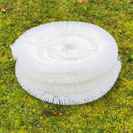Roll of white gutter guard mesh on grass