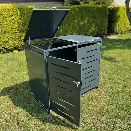Outdoor trash bin with open lid on grass